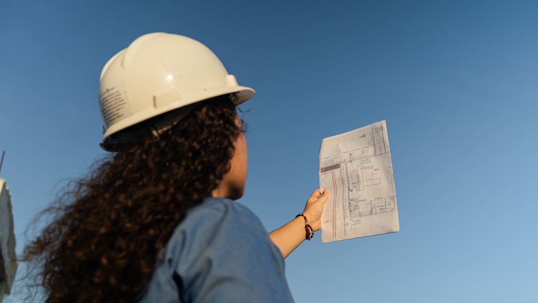 Architect reviewing project blueprints to document a contractor portfolio page