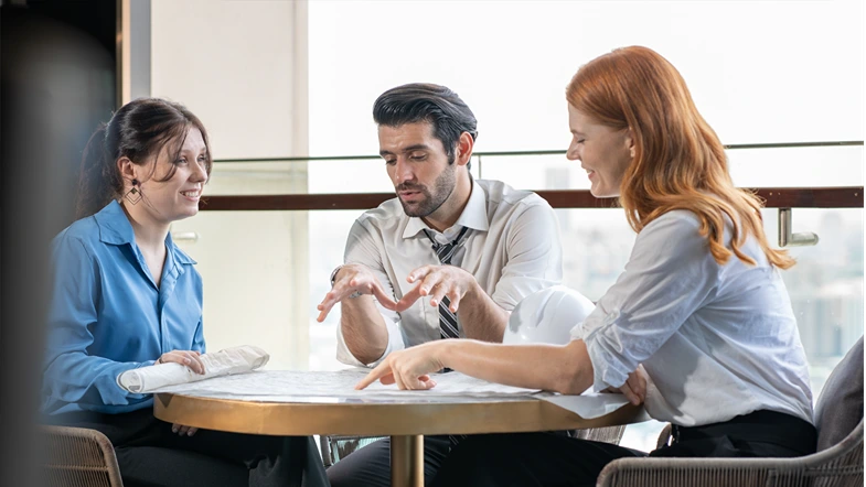Architect meeting with client explaining construction blueprint for building renovation project. Engineer manager discussion on renovation service agreement deal with customer. Construction industry.