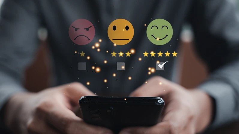 Man's hand giving 5-star rating feedback on smartphone for excellent service, customer satisfaction survey and business review. Concept of success and positive feedback