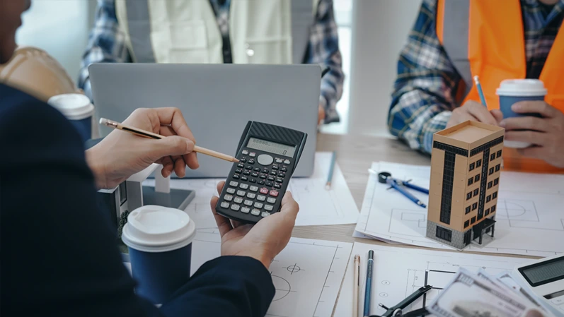Skilled team of engineers collaborates in meetings, drafting blueprints for condos, apartments, and houses. Negotiating costs, bids, and contracts, they ensure efficient cooperation on construction