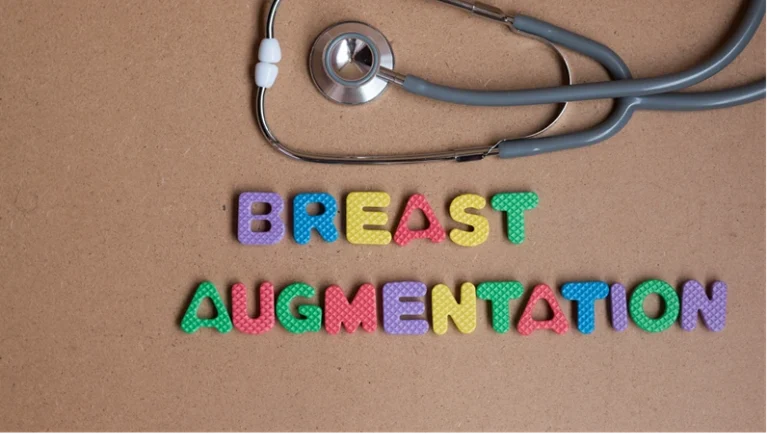 Breast augmentation colorful word on the brown background with stethoscope