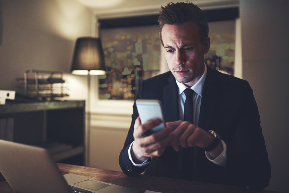 The professional lawyer sitting and using his phone in the evening.