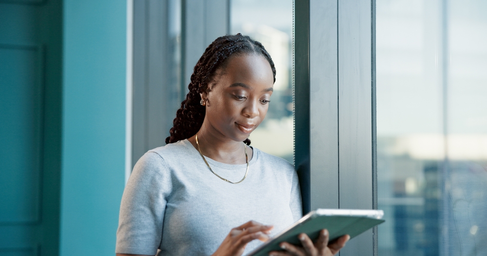 Business, reading and black woman with tablet in office for real estate 