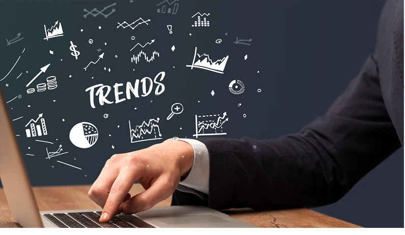 Businessman working on laptop with TRENDS inscription, modern business concept