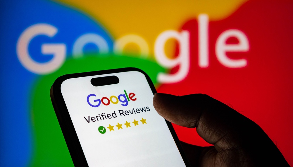 Closeup of a hand holding a smartphone displaying a google verified reviews