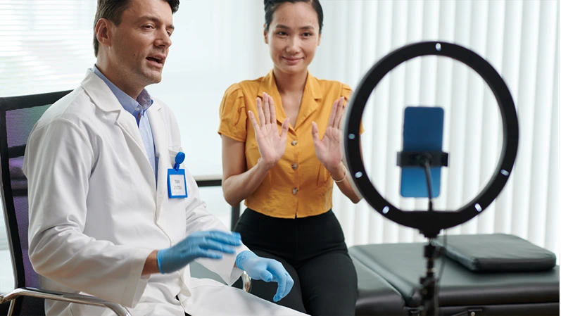 Plastic surgeon and his patient filming video for his blog